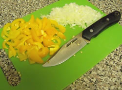 Slicing and dicing orange, pepper and onions